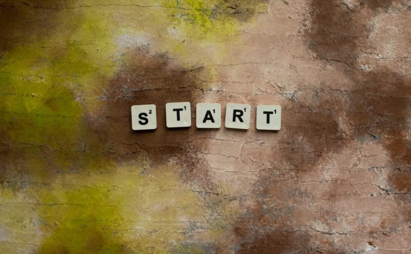 Scrabble letters spelling "START" on a textured earthy background.